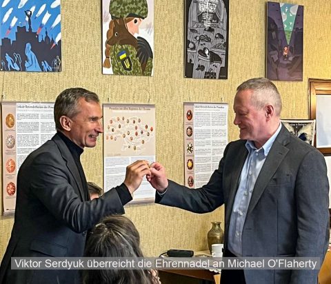 Michael O'Flaherty bekommt die Ehrennadel von Viktor Serdyuk